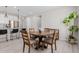 Dining area with wooden table and chairs, open to the kitchen with bar seating and stainless steel appliances at 18808 W Solano Dr, Litchfield Park, AZ 85340