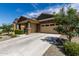 Exterior of a single Gathering home featuring a spacious driveway and desert landscaping at 18808 W Solano Dr, Litchfield Park, AZ 85340