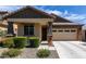 Inviting single-Gathering home showcasing a well-kept lawn and convenient two-car garage at 18808 W Solano Dr, Litchfield Park, AZ 85340