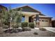 Charming single-Gathering home featuring a well-manicured front yard and a two-car garage at 18808 W Solano Dr, Litchfield Park, AZ 85340