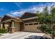 Exterior of a single Gathering home, featuring a wide driveway to the two car garage at 18808 W Solano Dr, Litchfield Park, AZ 85340