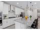 Bright kitchen featuring white cabinetry, stainless steel appliances, granite countertops, and modern pendant lights at 18808 W Solano Dr, Litchfield Park, AZ 85340