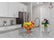 Close up of a kitchen island with stainless steel sink, granite counter tops, and a fruit bowl at 18808 W Solano Dr, Litchfield Park, AZ 85340