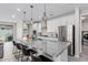 Spacious kitchen features a large island, granite countertops, stainless steel appliances, and stylish pendant lighting at 18808 W Solano Dr, Litchfield Park, AZ 85340