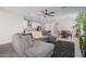 Open-concept living room blends seamlessly with the kitchen and dining area, featuring a comfortable gray sectional at 18808 W Solano Dr, Litchfield Park, AZ 85340