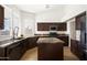 Stylish kitchen with wood cabinets, granite countertops, an island, and stainless steel appliances at 18873 N 94Th Way, Scottsdale, AZ 85255