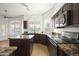 Stylish kitchen with wood cabinets, granite countertops, an island, and stainless steel appliances at 18873 N 94Th Way, Scottsdale, AZ 85255
