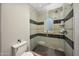 Modern bathroom features walk-in shower with decorative tile accents and glass door at 18927 N 101St St, Scottsdale, AZ 85255