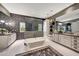 A luxurious bathroom features a soaking tub, glass-enclosed shower, dual vanities, and modern finishes at 18927 N 101St St, Scottsdale, AZ 85255