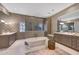 Luxurious bathroom with dual vanities, a freestanding tub, and a large walk-in shower at 18927 N 101St St, Scottsdale, AZ 85255