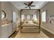 Cozy bedroom features a four-poster bed, plush rug, and ample natural light at 18927 N 101St St, Scottsdale, AZ 85255