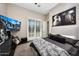 Stylish bedroom features a comfortable bed, modern decor, and a large screen television at 18927 N 101St St, Scottsdale, AZ 85255