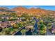 An aerial view shows the well-landscaped community with mountains in the background at 18927 N 101St St, Scottsdale, AZ 85255