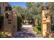 Picturesque courtyard with a central fountain, lush trees, and address markers at 18927 N 101St St, Scottsdale, AZ 85255