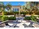 Backyard courtyard with a bubbling fountain, mature olive trees, and lounge seating at 18927 N 101St St, Scottsdale, AZ 85255