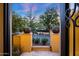 Inviting entry to this home features a view of the garden with mature trees at 18927 N 101St St, Scottsdale, AZ 85255