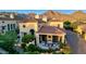 An aerial view shows the backyard and patio area, with seating, a fire pit, landscaping, and mountain views at 18927 N 101St St, Scottsdale, AZ 85255