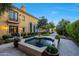 Beautiful backyard space with a fountain, lush greenery, and a relaxing patio at 18927 N 101St St, Scottsdale, AZ 85255