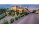 Inviting Mediterranean-style home boasts lush landscaping and charming brick driveway at 18927 N 101St St, Scottsdale, AZ 85255