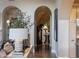 Grand foyer featuring arched doorways, hardwood floors and elegant staircase at 18927 N 101St St, Scottsdale, AZ 85255