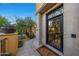 Inviting entryway featuring a beautiful wrought-iron door and stone accents at 18927 N 101St St, Scottsdale, AZ 85255