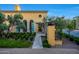 Beautiful home featuring an arched window and manicured garden at 18927 N 101St St, Scottsdale, AZ 85255