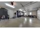 Clean three-car garage with storage cabinets and room for vehicles and other items at 18927 N 101St St, Scottsdale, AZ 85255