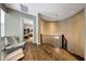 Second floor hallway with hardwood floors, a modern chandelier, and elegant railing at 18927 N 101St St, Scottsdale, AZ 85255