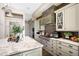 Gourmet kitchen with a central island, stainless steel appliances, and custom cabinetry at 18927 N 101St St, Scottsdale, AZ 85255