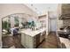 Open-concept kitchen featuring a large island with seating and lots of light at 18927 N 101St St, Scottsdale, AZ 85255