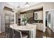 Well-equipped kitchen featuring a large island, stainless steel appliances, custom cabinetry, and modern lighting at 18927 N 101St St, Scottsdale, AZ 85255