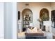 Elegant living room with arched built-in shelving and sophisticated decor at 18927 N 101St St, Scottsdale, AZ 85255