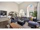 Spacious living room boasts a large sectional, arched doorways, and hardwood floors, perfect for entertaining and relaxing at 18927 N 101St St, Scottsdale, AZ 85255