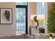 Stylish living room with elegant decor, decorative lamps, and an ornate door at 18927 N 101St St, Scottsdale, AZ 85255