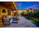 View of the covered patio shows the seating area with a fire pit and TV, plus a small private pool and landscaping at 18927 N 101St St, Scottsdale, AZ 85255