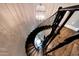 Unique birds-eye view of elegant spiral staircase with chandelier above at 18927 N 101St St, Scottsdale, AZ 85255