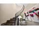 Elegant staircase with dark wood steps and decorative black iron railing at 18927 N 101St St, Scottsdale, AZ 85255