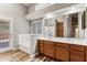 Spacious bathroom with double sinks, wood cabinets, soaking tub and a door to access the outside at 19127 N 79Th Dr, Glendale, AZ 85308