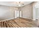 Bedroom features wood-look laminate flooring, neutral paint, ceiling fan and ensuite bathroom access at 19127 N 79Th Dr, Glendale, AZ 85308