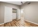 Bedroom with wood-look flooring, closet with sliding doors, and neutral colored walls at 19127 N 79Th Dr, Glendale, AZ 85308