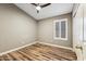 Bedroom features a ceiling fan, neutral paint, wood-look floors, and a window with shutters at 19127 N 79Th Dr, Glendale, AZ 85308