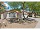 Single-story home with stucco exterior, terra cotta roof tiles, and a front yard featuring low-maintenance desert landscaping at 19127 N 79Th Dr, Glendale, AZ 85308