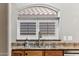 Stainless steel kitchen sink with wood cabinets, granite countertops, and a window bringing in plenty of natural light at 19127 N 79Th Dr, Glendale, AZ 85308
