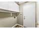 Convenient laundry room with storage cabinets and access to the exterior at 19127 N 79Th Dr, Glendale, AZ 85308