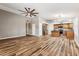 Spacious living room with wood-look laminate flooring open to the kitchen with stainless steel appliances at 19127 N 79Th Dr, Glendale, AZ 85308