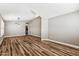 Spacious living room with wood-look floors, contemporary lighting, and an open layout at 19127 N 79Th Dr, Glendale, AZ 85308