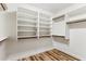 Walk-in closet featuring custom shelving and laminate wood-look floors for maximum storage at 19127 N 79Th Dr, Glendale, AZ 85308