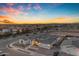 Aerial view of a luxury home featuring lush landscaping, a circular driveway, and a grand entrance at dusk at 20426 E Arroyo Verde Dr, Queen Creek, AZ 85142