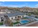 Stunning aerial view of custom home with backyard pool, fire pit, and desert landscape at 20426 E Arroyo Verde Dr, Queen Creek, AZ 85142