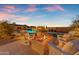 Backyard with a fire pit and pool at dusk at 20426 E Arroyo Verde Dr, Queen Creek, AZ 85142